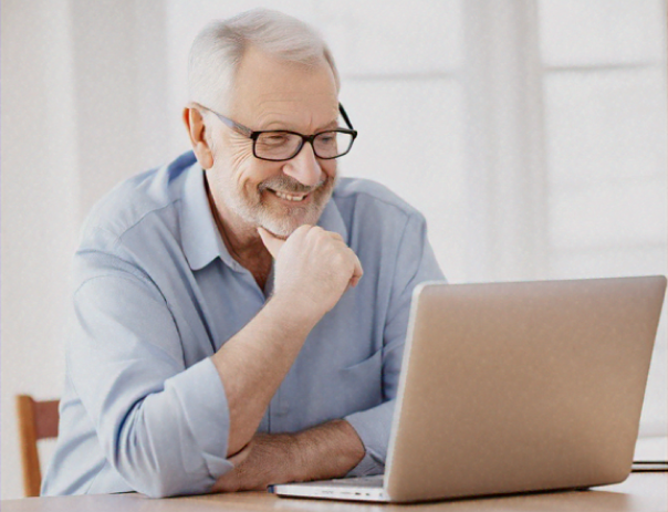 A gentleman looking at a laptop